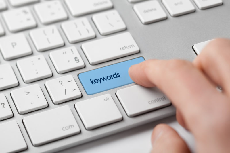 blue button on a keyboard that says keywords