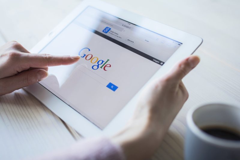 homeowner using ipad to search for home service companies on google