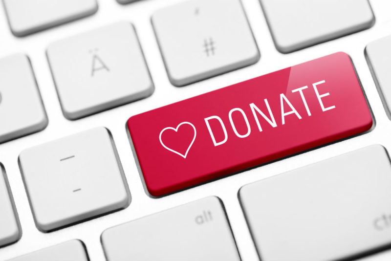 red donate button on keyboard with a heard