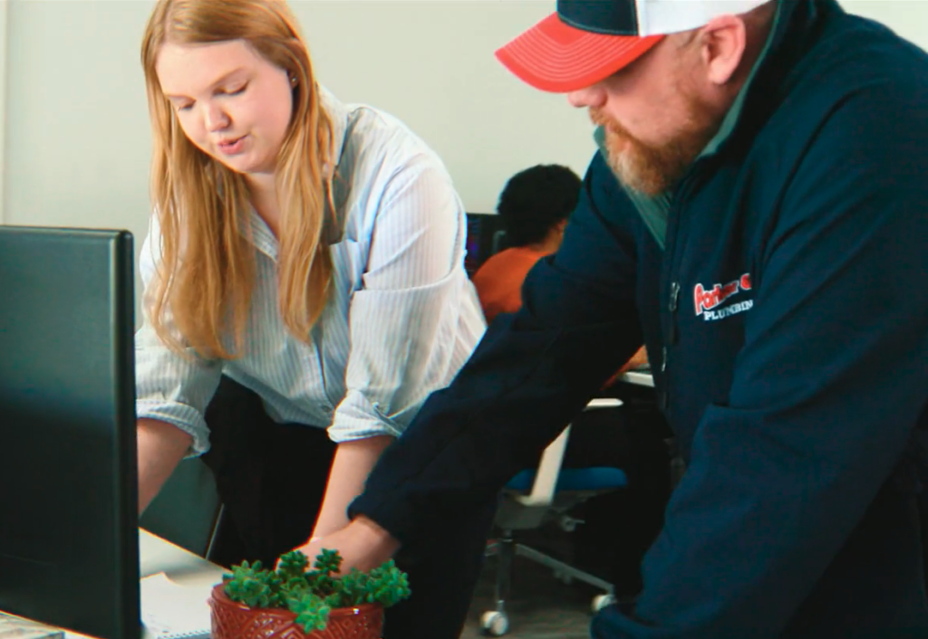 friendly leadhub marketing employee talking to the owner of a plumbing company