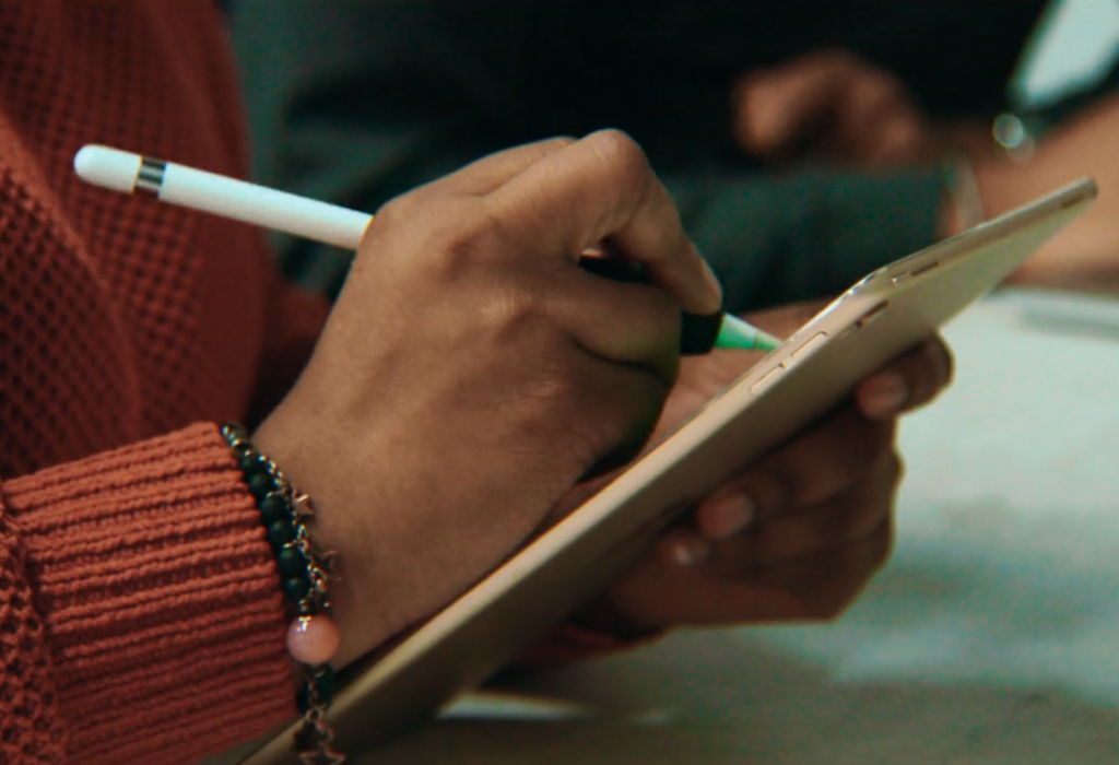 technician writing on an ipad